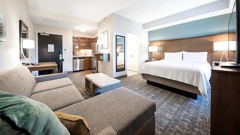 Settle into a modern suite with kitchenette convenience and calm comfort.