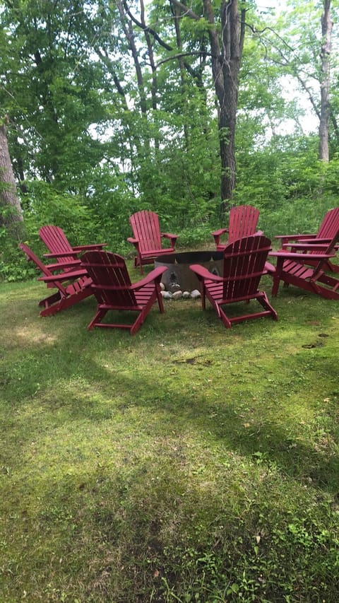 Adirondack chairs around lakeside firepit