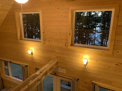 Looking through the window in the Master Suite past the cathedral ceiling to the lake