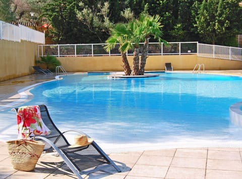 Lounge by the seasonal outdoor pool in the sunshine.