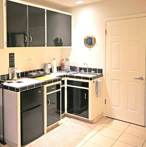 The kitchenette in Unit 1 has a mini-fridge, microwave, toaster, hotplate & more