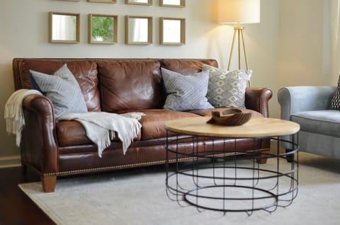 The front door opens into a light-soaked living area with high ceilings.