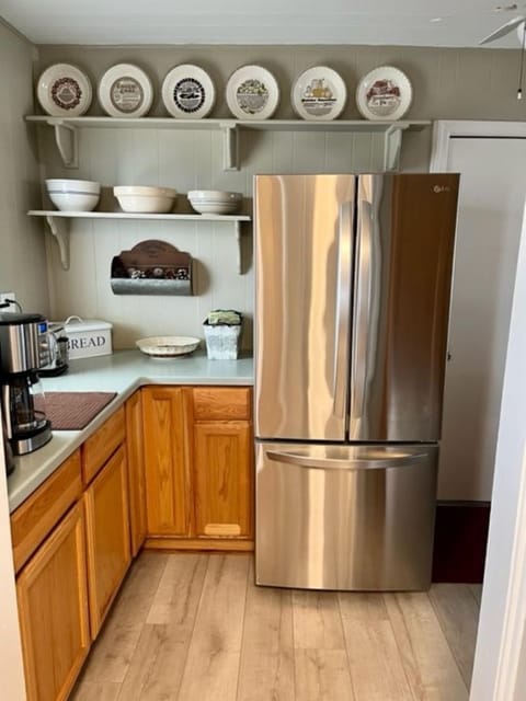Stainless steel refrigerator with easy access for cook and coffee bar