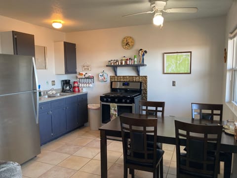 kitchen area includes seating for four with full size refrigerator, stove/oven
