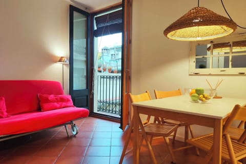 4th floor. The room is bathed in natural light from a set of French doors that open onto a small balcony overlooking a quiet courtyard.