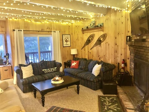 Large living room with fireplace, Smart TV, futon and plenty of comfy seating. 