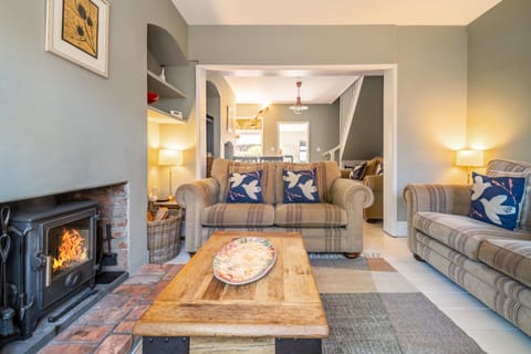 Number 22, Aldeburgh: Cosy open-plan living area with a wood burning stove