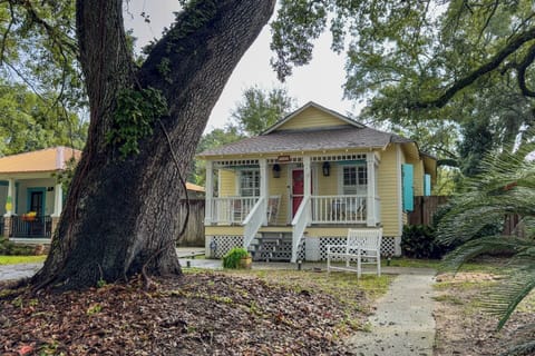 Adorable coastal cottage with a welcoming front porch, shaded yard, and classic Southern charm.