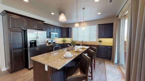 Fully stocked kitchen has a large island with seating for 3, 2 sinks, reverse osmosis drinking water and deluxe appliances