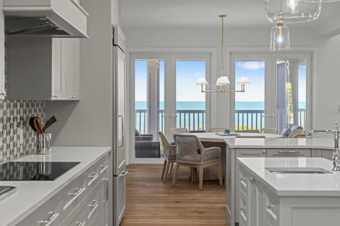Beautiful white chef's kitchen with a breakfast bar and state-of-the-art appliances.