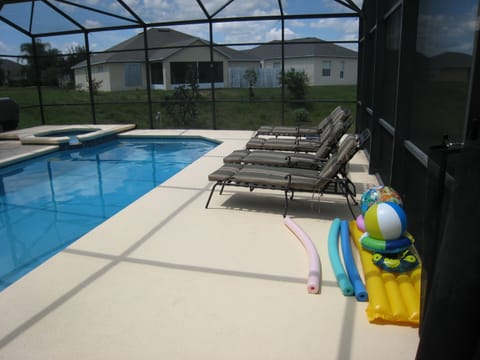 Southwest facing pool, spa and deck, covered lanai. Overlooks retention pond