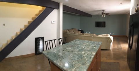 Open plan kitchen and living space. Stairs lead to master suite.