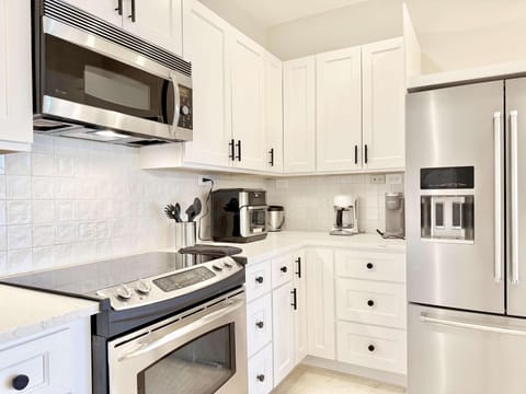 Bright, modern kitchen with stainless steel appliances and ample storage