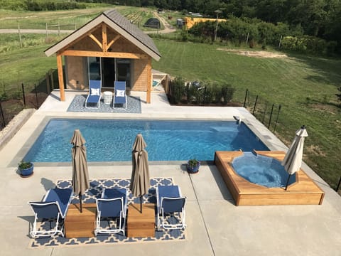 View of pool and patio area with farm in background
