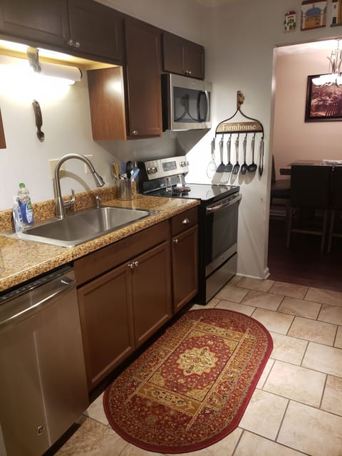 Full kitchen with utensils, dinnerware, cookware, and few spices