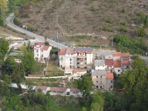 aerial -rear of property, parking with car ports and river valley in foreground