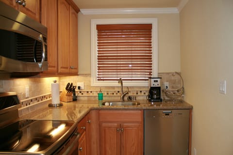 Kitchen with garbage disposal, Miele dishwasher, SHARP Saber knives in block