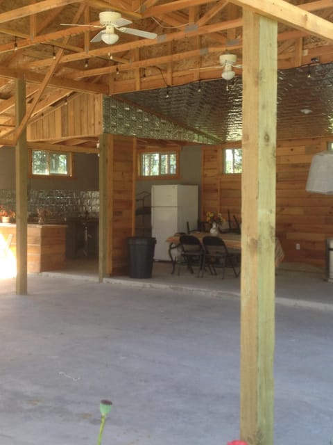 Large covered pavilion with ceiling fans, heaters, refrigerator, sink and bar