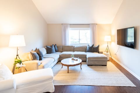 Living room - large, comfy couch, plenty of room for everyone! Large 65" TV