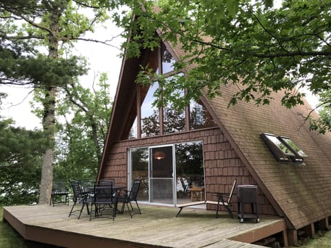 Back view of cabin showing the deck just steps away from the lakeshore 