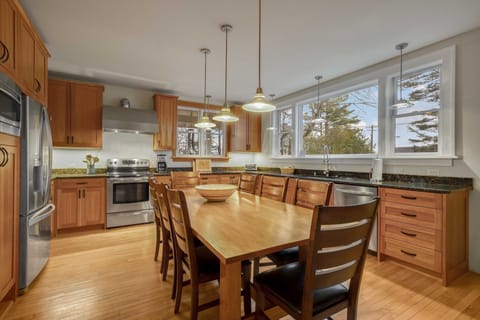 The beautiful kitchen area,  with plenty of windows, light and a table for 8!