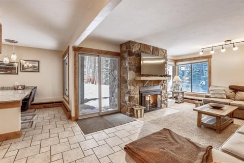 Living area with gas fireplace - Open concept living area and kitchen with patio out the glass sliding door