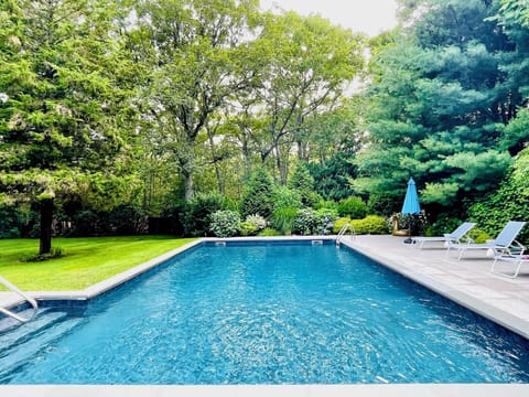Beautiful outdoor pool with loungers and umbrellas