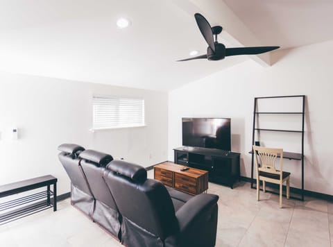 Guest Unit Living Room with Reclining Sofa, 55" TV, and Office Desk