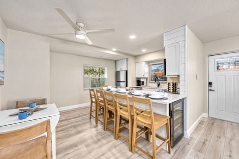 A casual setup with stools for dining or chatting while meals are prepared in the adjacent kitchen.