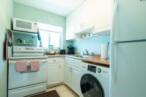 Fully equipped kitchen includes a washer/dryer combo unit for your convenience