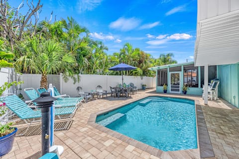 From the comfort of the chaise lounges, take in the inviting heated pool surrounded by swaying palms.