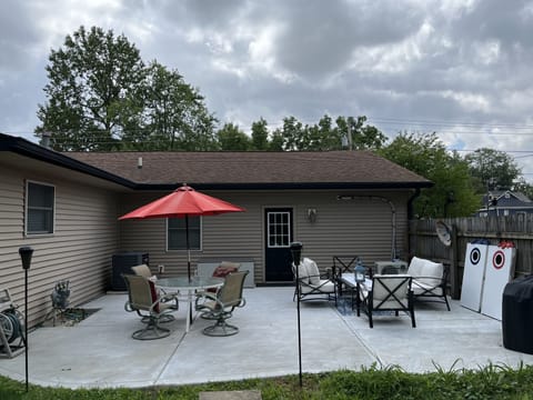 Nice patio complete with Furniture, Corn Hole tables & Charcoal Grill