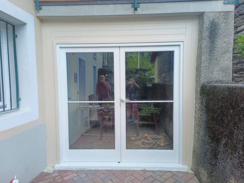 Double doors below balcony for extra privacy, space and storage.