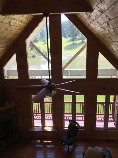 Two story living room view from above open hallway.  Lovely views, lots of glass