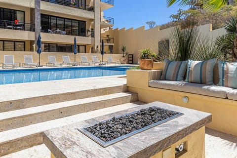 Beautiful shared terrace area with comfortable seating and cozy fire feature.