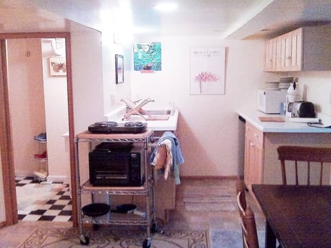 Kitchen, bath and dining area with lots of dishes, cutlery and appliances. 