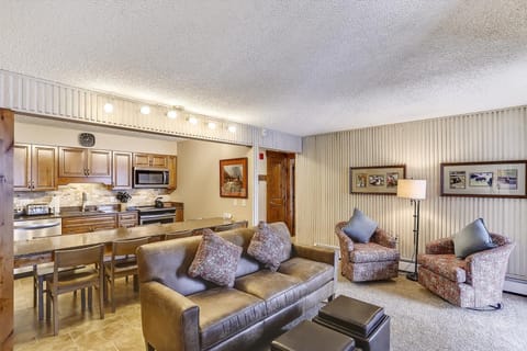 Living Room - Open concept kitchen / living room with views of the slopes and a cozy gas fireplace