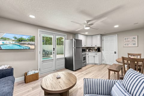 The open layout connects living, dining, and kitchen in one cozy, sunlit space—perfect for relaxing or gathering.