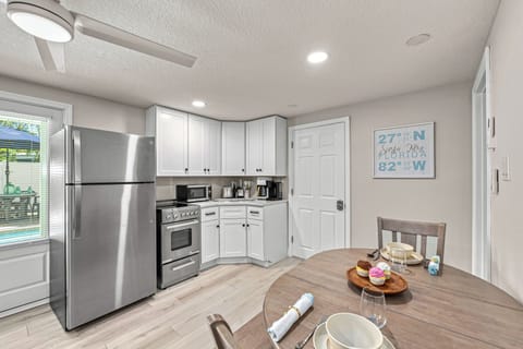 A bistro-style dining table sits adjacent to the open kitchen, great for casual meals or planning your day over coffee.