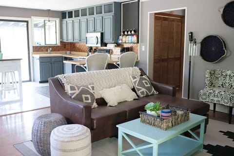 Comfortable den with open concept kitchen leading out to a screened in porch