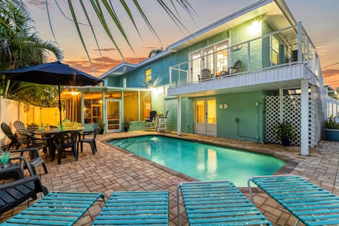 Soft lights reflect off the water as the sun dips—perfect for an evening swim or cocktail.