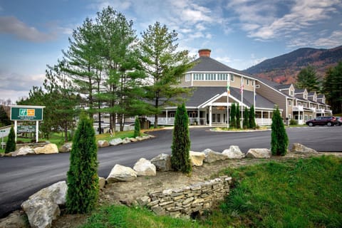 Resort entrance surrounded by trees and mountains.
