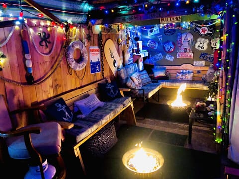 Unique patio, lounging, smoking area with propane fire pits.