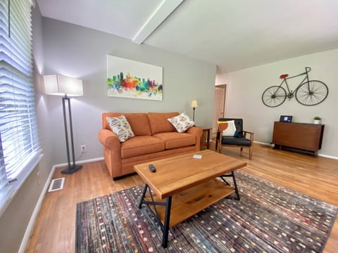 Spacious living room with hardwoods, large bay window and 54" Roku TV. 