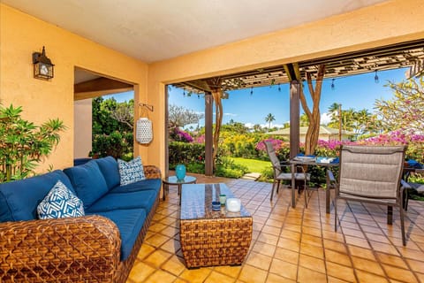 Everything you need to live outdoors --- an outdoor sofa and eating area.