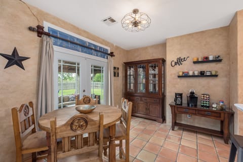 Eat in kitchen, coffee bar, hutch with wine glasses & flow to outside living 