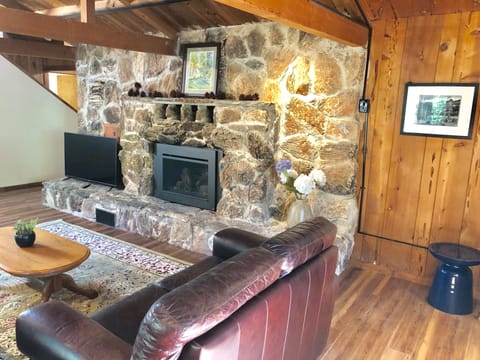 Large stone fireplace in great room with gas insert on timer