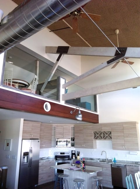 Kitchen and island with loft/interior deck above it