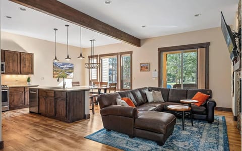 Living Room/Kitchen/Dining: Alder Cabinets, Leather Sectional, LCD TV
