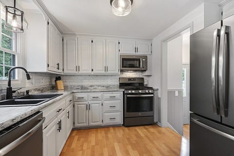 Kitchen - gas range, OTR microwave, dishwasher, and french door refrigerator